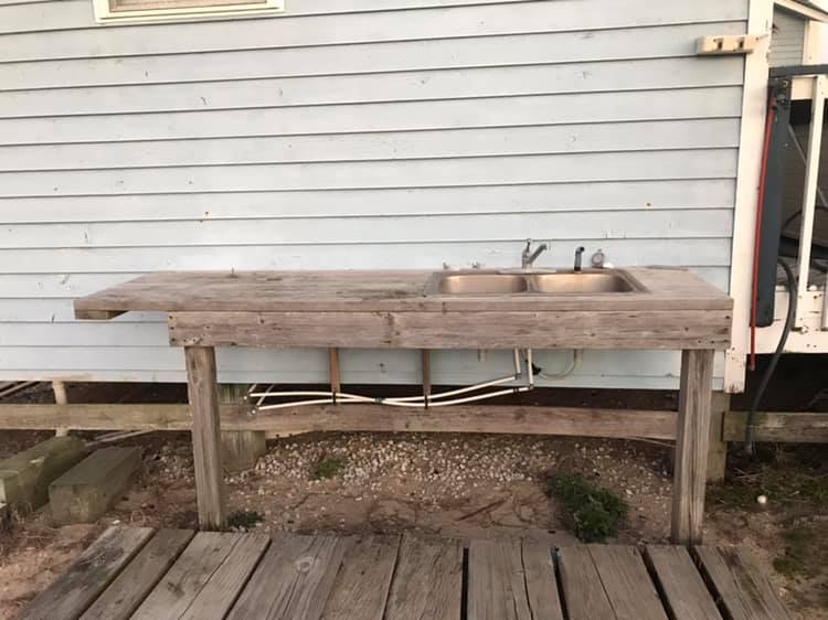 Fish cleaning table with sink
