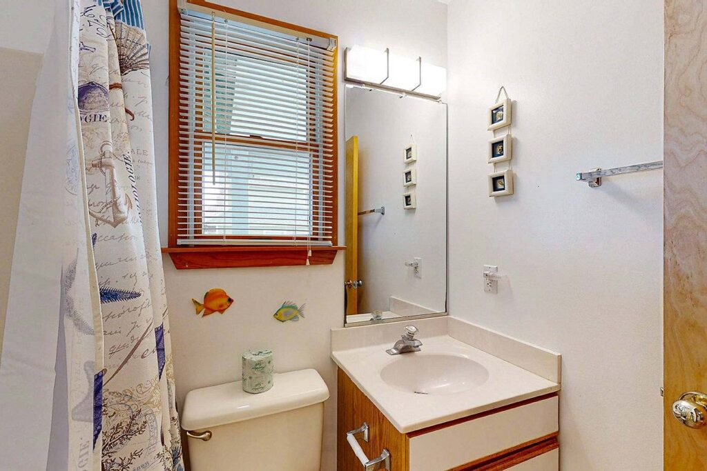 Middle level shared bathroom near laundry room